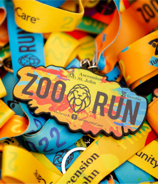 a bunch of medals saying zoo run